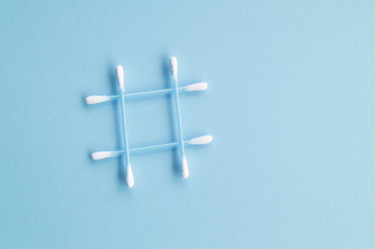 cotton swabs in the form of a hashtag on a blue background