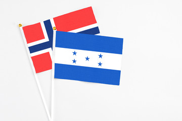 Honduras and Bouvet Islands stick flags on white background. High quality fabric, miniature national flag. Peaceful global concept.White floor for copy space.
