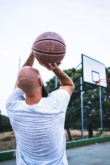 Young basketball player shooting a triple