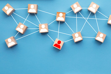 Wooden blocks connected together on a blue background. Teamwork concept