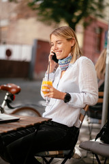 Beautiful businesswoman in cafe. Young woman responding on email while sitting in cafe.