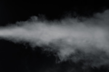 Smoke spray spit from left side on black background.