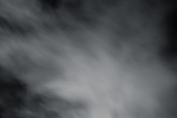 Smoke spray spread with wind on black background. Soft blur fog spread around