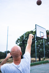 Young basketball player shooting a triple