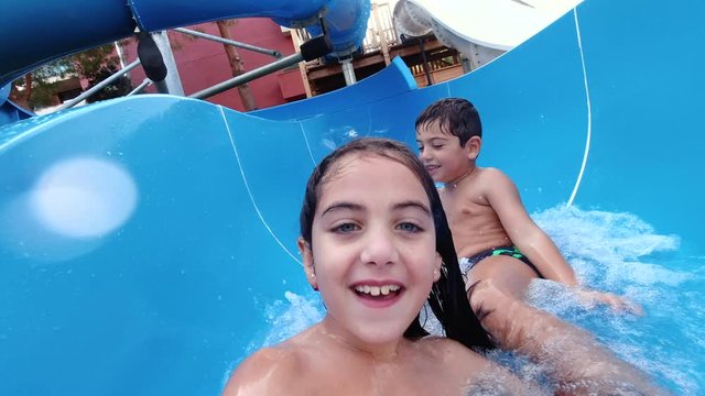 Child pulling down a water slide