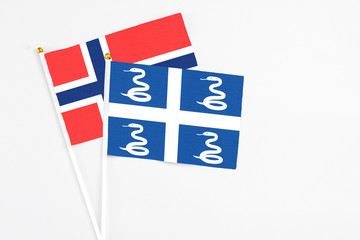 Martinique and Bouvet Islands stick flags on white background. High quality fabric, miniature national flag. Peaceful global concept.White floor for copy space.