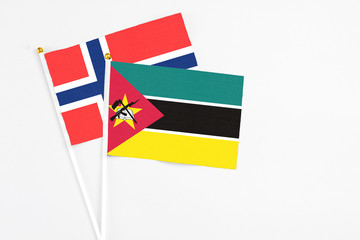 Mozambique and Bouvet Islands stick flags on white background. High quality fabric, miniature...