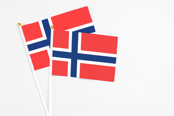 Norway and Bouvet Islands stick flags on white background. High quality fabric, miniature national flag. Peaceful global concept.White floor for copy space.