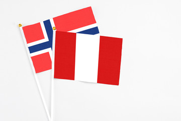 Peru and Bouvet Islands stick flags on white background. High quality fabric, miniature national flag. Peaceful global concept.White floor for copy space.