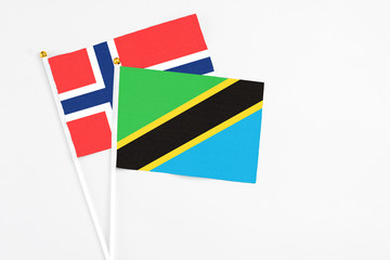 Tanzania and Bouvet Islands stick flags on white background. High quality fabric, miniature national flag. Peaceful global concept.White floor for copy space.
