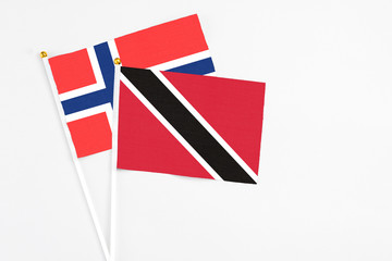 Trinidad And Tobago and Bouvet Islands stick flags on white background. High quality fabric, miniature national flag. Peaceful global concept.White floor for copy space.