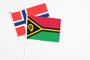 Vanuatu and Bouvet Islands stick flags on white background. High quality fabric, miniature national flag. Peaceful global concept.White floor for copy space.