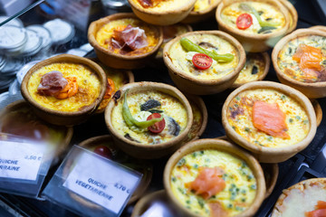 French quiches in assortment on market counter