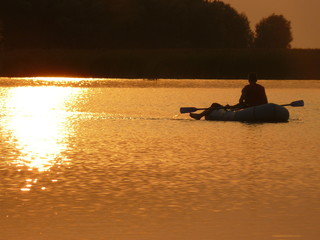 two in a boat at sunset