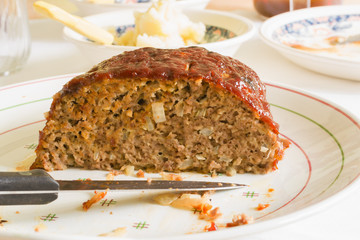 Classic American meatloaf made with ground beef oatmeal onions and a ketchup brown sugar and...