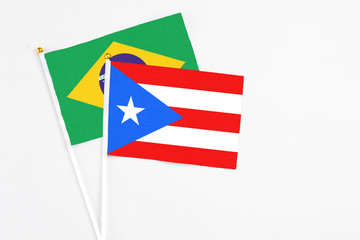 Puerto Rico and Brazil stick flags on white background. High quality fabric, miniature national flag. Peaceful global concept.White floor for copy space.