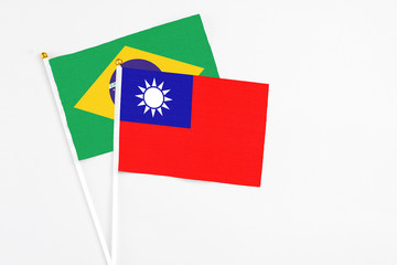 Taiwan and Brazil stick flags on white background. High quality fabric, miniature national flag. Peaceful global concept.White floor for copy space.