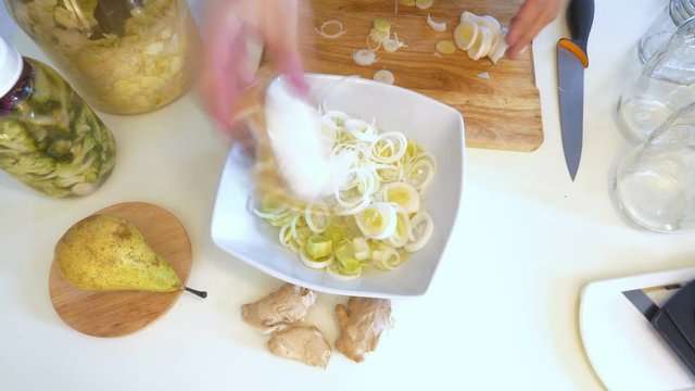 Time lapse of the preparation of a leak chucrut with pear and ginger. Fermented food recipe.