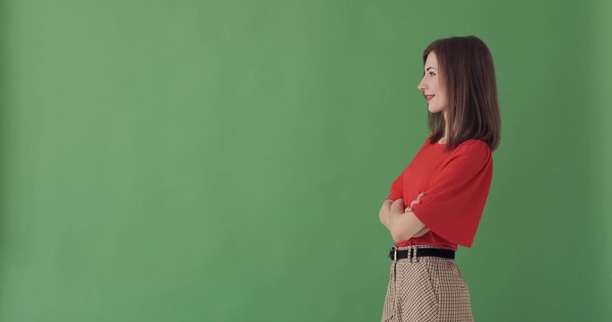 Happy businesswoman appearing on green screen and standing with her arms crossed