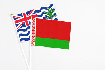 Belarus and British Indian Ocean Territory stick flags on white background. High quality fabric, miniature national flag. Peaceful global concept.White floor for copy space.