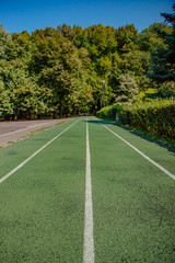 Treadmill in sport field with green grass and sunlight.