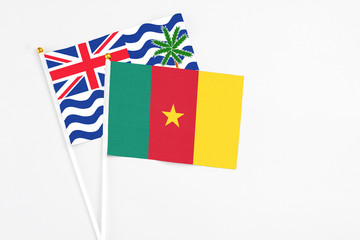 Cameroon and British Indian Ocean Territory stick flags on white background. High quality fabric, miniature national flag. Peaceful global concept.White floor for copy space.