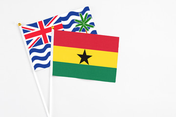 Ghana and British Indian Ocean Territory stick flags on white background. High quality fabric, miniature national flag. Peaceful global concept.White floor for copy space.