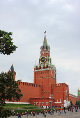 Fototapeta na wymiar Kremlin on the Red Square in Moscow, Russia. Close up of Spasskaya Tower architecture on cloudy summer day 