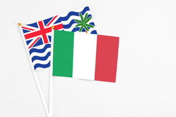 Italy and British Indian Ocean Territory stick flags on white background. High quality fabric, miniature national flag. Peaceful global concept.White floor for copy space.