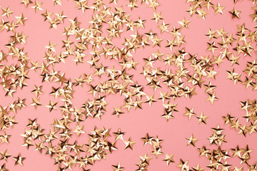 small golden stars on pink background