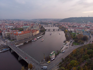 Fototapeta na wymiar Prague bridges aerial view at autumn in twilight cloudy day, blue hour