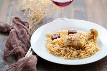 chicken with smoked sausage and rice on white plate
