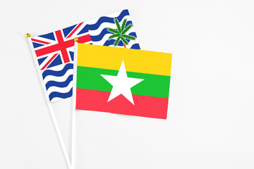 Fototapeta premium Myanmar and British Indian Ocean Territory stick flags on white background. High quality fabric, miniature national flag. Peaceful global concept.White floor for copy space.