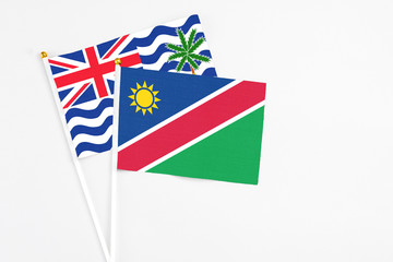 Namibia and British Indian Ocean Territory stick flags on white background. High quality fabric, miniature national flag. Peaceful global concept.White floor for copy space.
