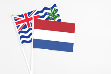 Netherlands and British Indian Ocean Territory stick flags on white background. High quality fabric, miniature national flag. Peaceful global concept.White floor for copy space.