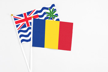 Romania and British Indian Ocean Territory stick flags on white background. High quality fabric, miniature national flag. Peaceful global concept.White floor for copy space.