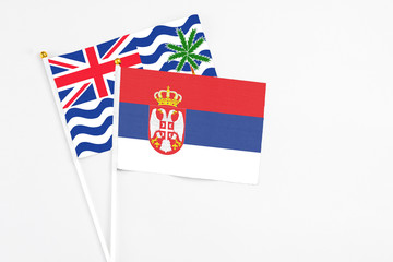 Serbia and British Indian Ocean Territory stick flags on white background. High quality fabric, miniature national flag. Peaceful global concept.White floor for copy space.