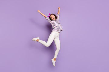 Fototapeta na wymiar Full length body size view of her she nice attractive lovely cheerful cheery girl jumping having fun time celebrating cool accomplishment isolated over violet purple lilac pastel color background