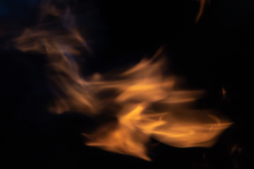 Fototapeta premium Soft blur flame from moving around in center with some blue flame on black background. For overlay effect