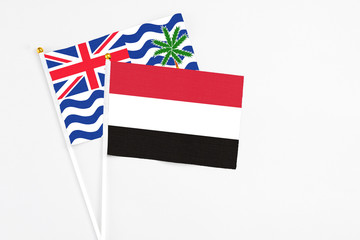 Yemen and British Indian Ocean Territory stick flags on white background. High quality fabric, miniature national flag. Peaceful global concept.White floor for copy space.