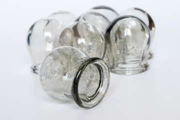 Massage jars for therapeutic massage on white background