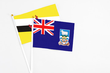 Falkland Islands and Brunei stick flags on white background. High quality fabric, miniature...