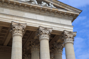 Fototapeta na wymiar Vintage Old Justice Courthouse Column. Neoclassical colonnade with corinthian columns as part of a public building resembling a Greek or Roman temple