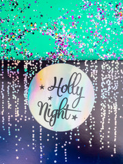 Colorful Sparkling Glitter confetti. Christmas Holidays abstract background, ispired by blue and neo mint, color of 2020, holly night text in holographic paper
