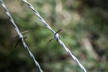 close detail of fence with barbed wire
