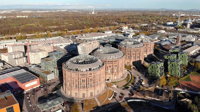Aerial drone shot of Old Gasometer buidlings in Vienna from up above. Used like gasholders, it is music hall, museum, dormitory and shopping center howadays