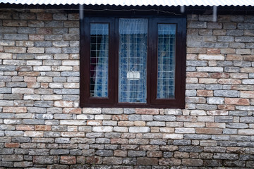 Fototapeta na wymiar Modern window with skyscraper view in brick wall