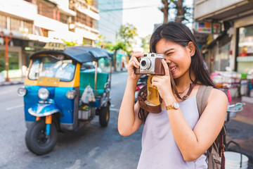Asian girl visiting and taking photo in Bangkok