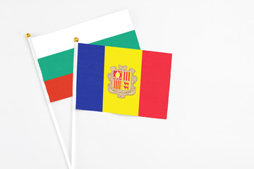 Andorra and Bulgaria stick flags on white background. High quality fabric, miniature national flag. Peaceful global concept.White floor for copy space.
