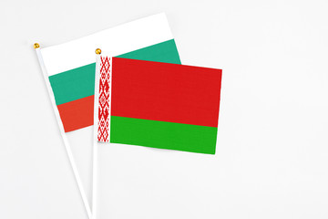 Belarus and Bulgaria stick flags on white background. High quality fabric, miniature national flag. Peaceful global concept.White floor for copy space.
